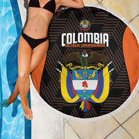 Round black beach blanket with white fringe, orange border, and Colombia crest graphic