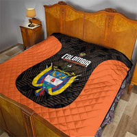 Orange and black quilt laid over bed with central Colombia crest and diamond quilting