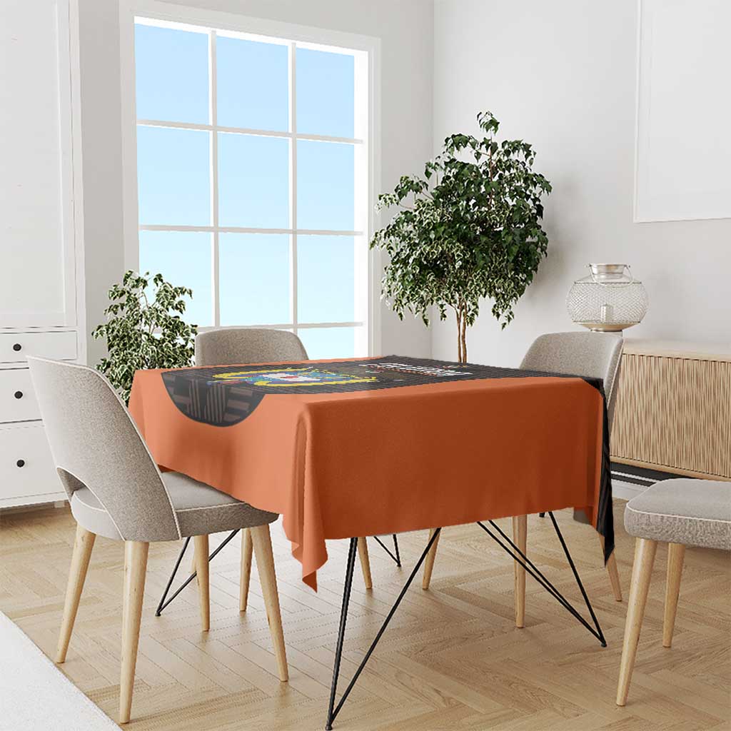 Orange football tablecloth with black printed center panel on dining table