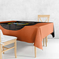Orange football tablecloth showing black circular emblem on table surface