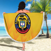 Yellow round beach blanket with white fringe, Colombia crest held up outdoors on sand