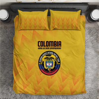 Yellow football bedding set with orange zigzag pattern and Colombia crest on duvet and pillows.