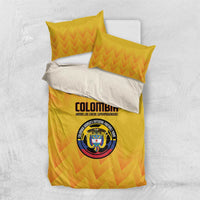 Yellow bedding set with orange zigzag pattern; Colombia logo centered on the duvet, matching pillows.