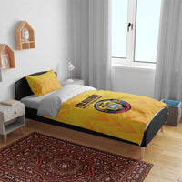 Yellow football duvet set with orange zigzag print and Colombia crest patch on the bed cover.