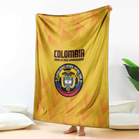 Yellow Colombia football blanket draped upright, showing crest emblem and logo text