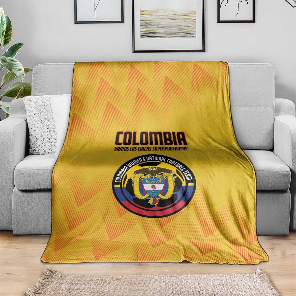 Yellow Colombia football blanket over a sofa cushion, with large crest emblem