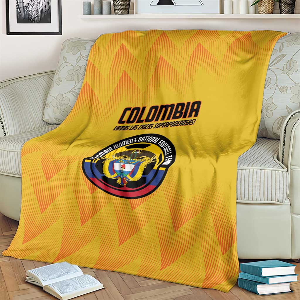Yellow Colombia football blanket on a couch with crest logo and orange zigzag pattern