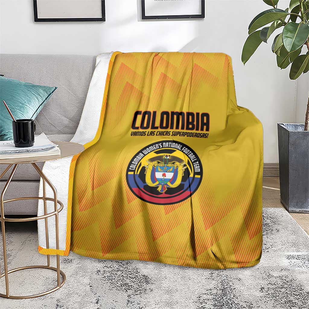 Yellow Colombia football blanket folded over a chair, featuring crest emblem and text