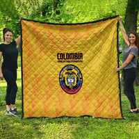 Yellow Colombia football quilt blanket with quilted texture, crest logo centered, black trim
