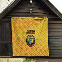 Yellow Colombia football quilt hanging indoors, quilted diamonds with crest logo and text