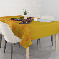 Yellow football-themed tablecloth with printed crest, angled over a dining table.