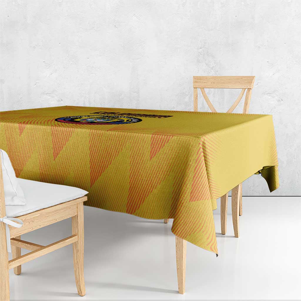 Yellow football tablecloth with graphic circular crest in the center, draped over table.