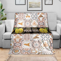 Personalized Sicilia mosaic blanket with custom “YOUR TEXT” band, draped over sofa