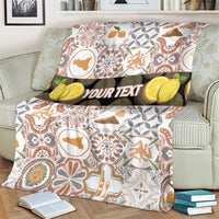 Personalized Sicilia patterned blanket with custom “YOUR TEXT” band, folded over loveseat
