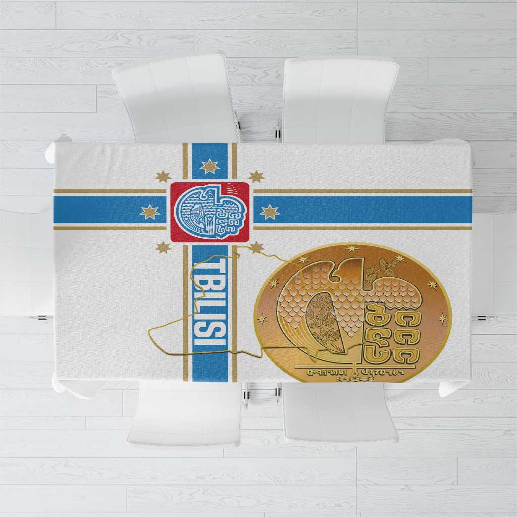 White tablecloth with blue border stripe and gold circular emblem print