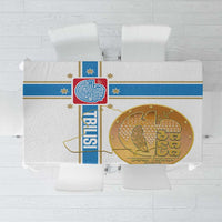 White tablecloth with blue border stripe and gold circular emblem print