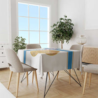 White tablecloth with blue side stripe and gold emblem on dining table