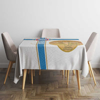 White tablecloth with blue border stripe and gold emblem on dining table