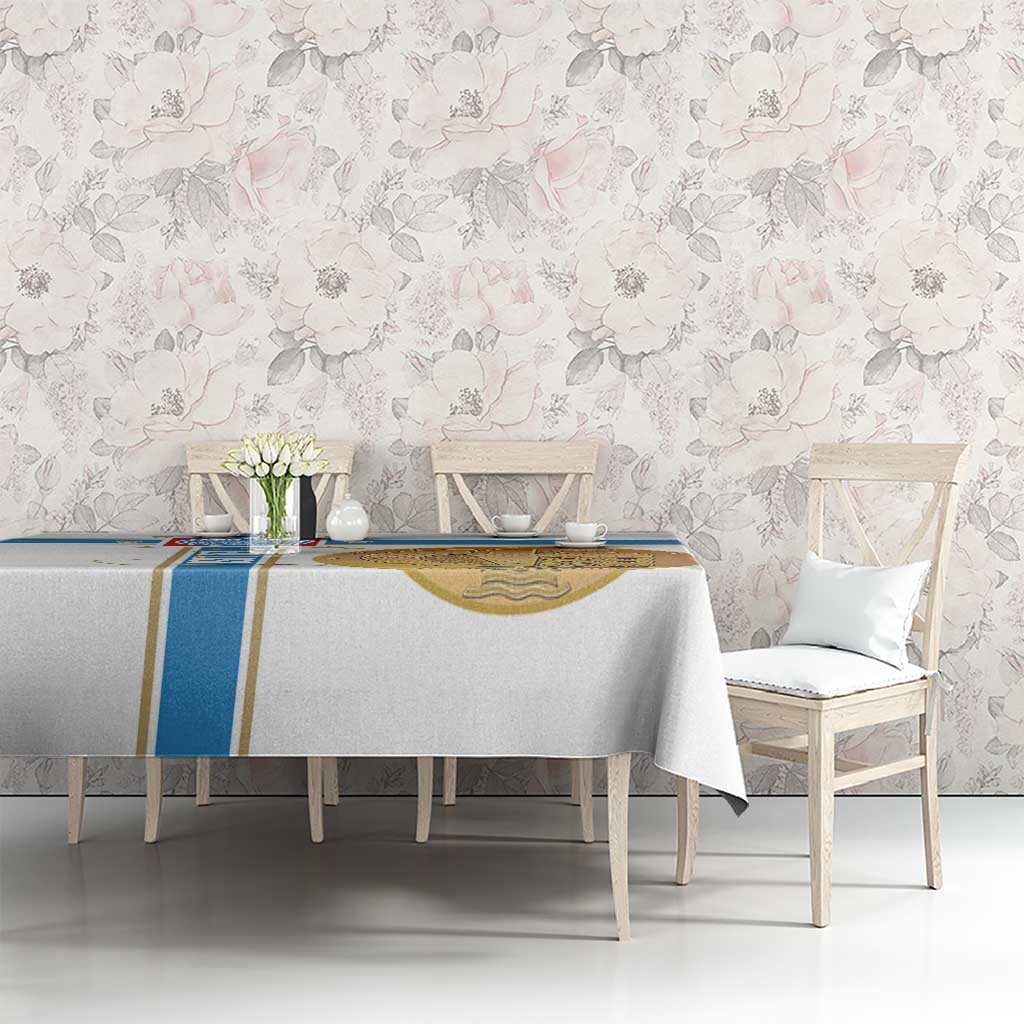 White tablecloth with blue stripe and gold emblem panel