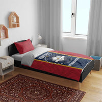 Red bed cover set with two matching pillows featuring blue circular state seal design