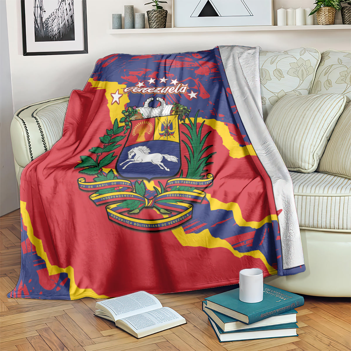 Venezuela flag-themed blanket draped on a sofa, red and blue grunge flag graphic with books