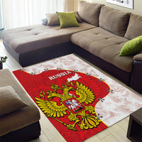 Red and white Russia coat-of-arms area rug with eagle crest under living room sofa