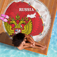 Round beach blanket spread out with Russia coat of arms, map graphic, fringed border