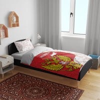 Red and white bedding set on bed featuring Russia coat of arms and map graphic