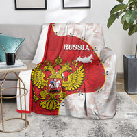 Russia flag blanket with red crest and white map, laid across gray sofa back