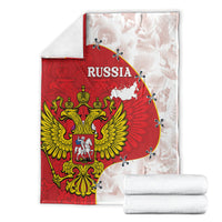 Folded Russia-themed red and white blanket set with crest and map design, plus rolled towels
