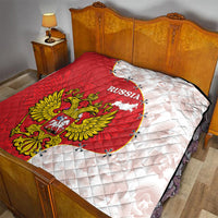 Red and white Russia quilt on bed, showing map outline and golden eagle crest
