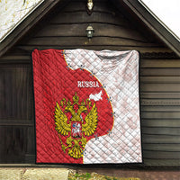 Red and white Russia quilt hanging on a covered porch with eagle and map graphics