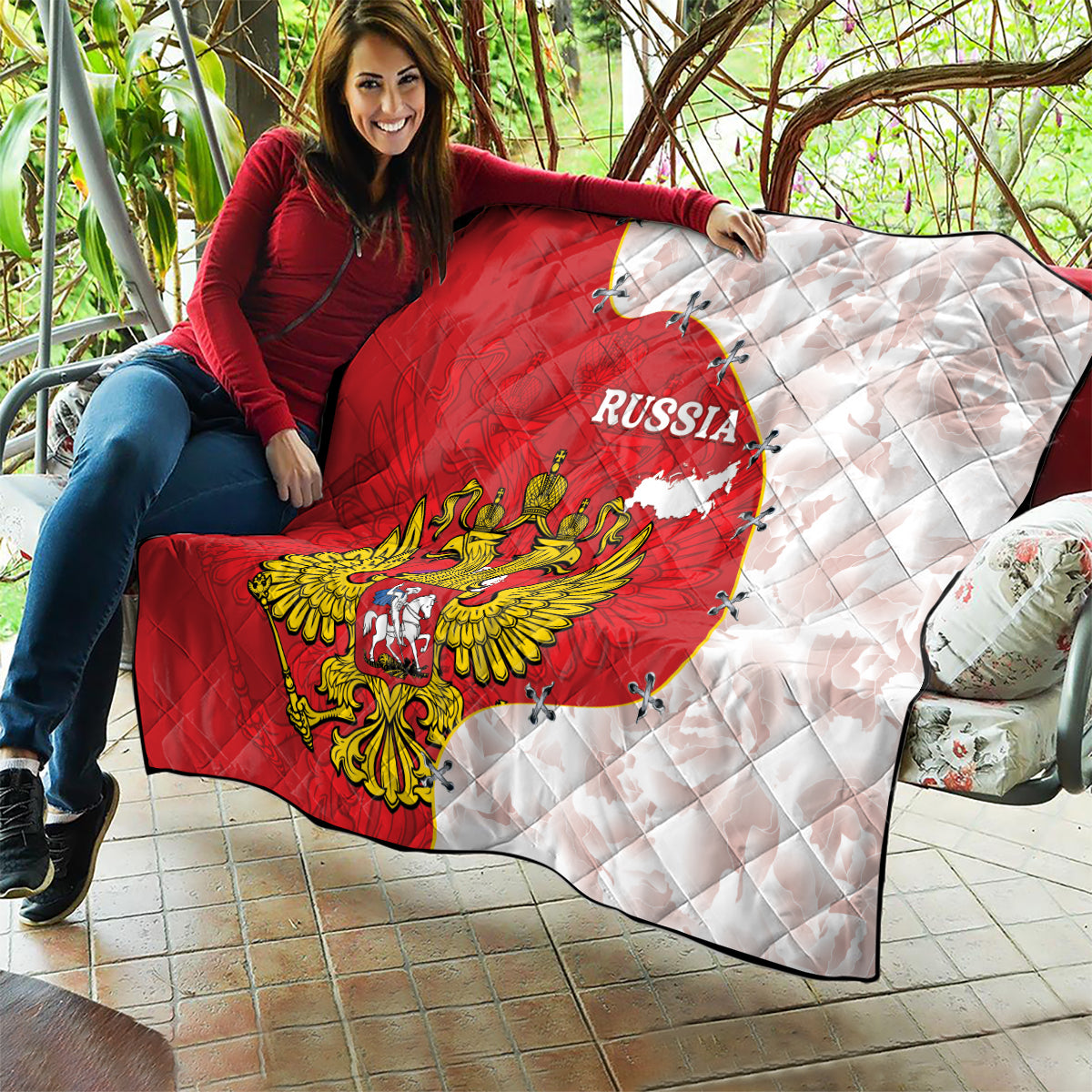 Red and white Russia quilt on outdoor seating, with eagle emblem and map outline