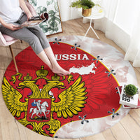 Round red carpet rug showing RUSSIA text, golden eagle crest, white map and edge planes