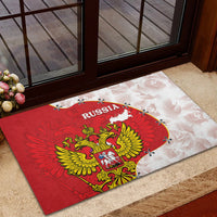 Red rubber doormat with Russia coat-of-arms over map print, black border