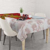 Red and white tablecloth with coat of arms and map-style silhouettes on table