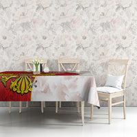 Red and white tablecloth with crest and map silhouettes on dining table