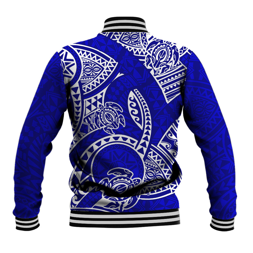 Blue baseball jacket back with large white tribal honu and tiki patterns, striped ribbed hem