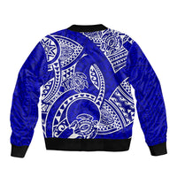 Blue bomber jacket with large back Polynesian tribal honu graphic and ribbed hem