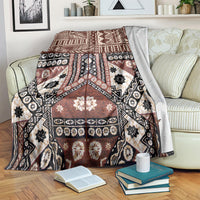 Brown masi tapa pattern blanket with black and white geometric motifs
