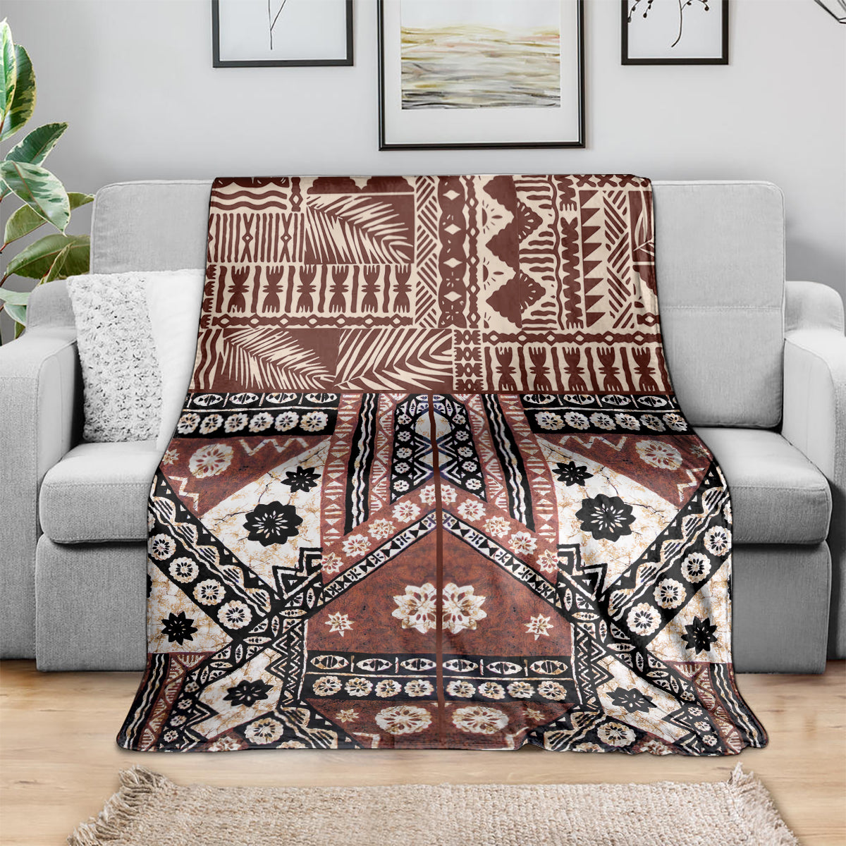 Brown tapa-pattern throw blanket with black and white floral and geometric details