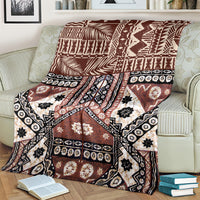Brown and black tapa-pattern blanket with white flower and star-like motifs