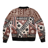 Brown bomber jacket with black ribbed hem and bold geometric tapa pattern on back