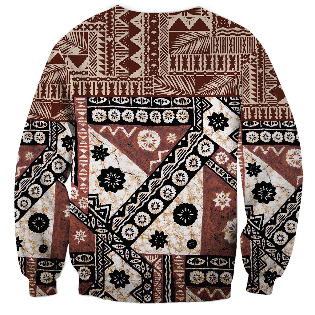 Brown crewneck sweatshirt with long sleeves, bold geometric tapa-style collage print.