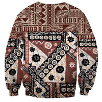 Brown crewneck sweatshirt with long sleeves, bold geometric tapa-style collage print.