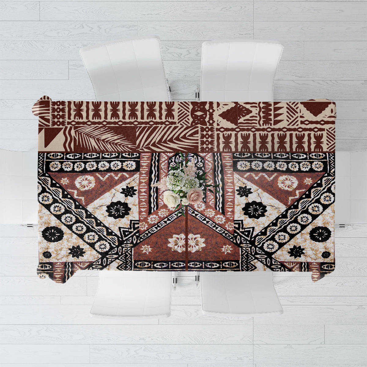 Brown masi tapa patterned tablecloth with geometric border and floral motifs.
