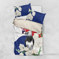 Folded flat-lay bedding set with harpy eagle center art, blue panels, red flag-style band