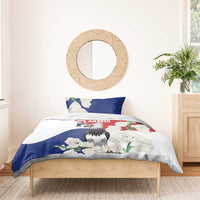 Harpy eagle bedding set on bed with blue swirl border, red band, and white floral print