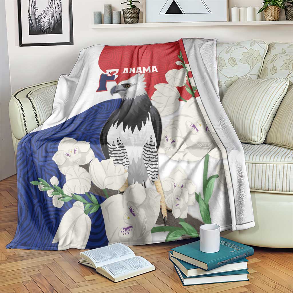 Flag-style throw blanket with harpy eagle, red blue white floral mola pattern, draped on sofa