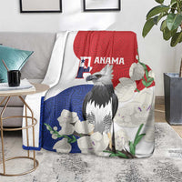Flag-style throw blanket with harpy eagle, red blue white floral mola pattern, draped over chair